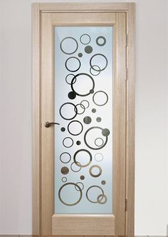 a glass door with circles on it and a wooden floor in front of the door