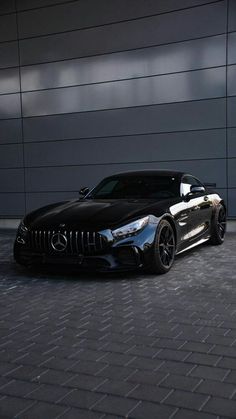 a black sports car parked in front of a building