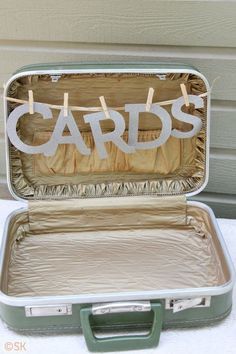 an open suitcase sitting on top of a table next to a sign that says cards