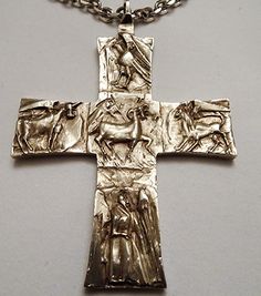 a silver cross with jesus and other animals on it