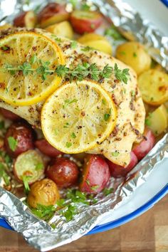 grilled chicken with potatoes and lemons in foil