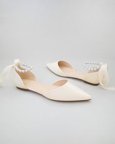 Satin pointy toe flats with satin ankle tie or ballerina lace up. Comfortable wedding shoes throughout ceremony and reception to dance the night away. *** YOU CAN ALSO CHOOSE STYLE OF ANKLE STRAP AT CHECKOUT*** DETAILS: UPPER: Synthetic upper and lining MATERIALS: Manmade outsole ORIGIN: Imported Elegant Pearl Embellished Flats For Formal Occasions, Elegant Pearl-embellished Formal Flats, Elegant Pearl Embellished Formal Flats, Elegant Ankle Tie Wedding Shoes For Spring, Elegant Bridesmaid Pointed Toe Flats, Elegant Cream Low Heel Flats, Chic Low Heel Ballet Flats For Wedding, Elegant Wedding Ballet Flats, Elegant Ankle Strap Ballet Flats