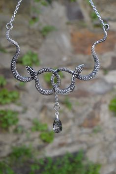 Gothic silver double snake necklace with black crystal drop or your choice. Stainless steel chain. PLEASE read my shop announcement before placing an order so you know what to expect right now. Plus, when ordering from outside Europe, don't forget to provide a phone number for the courier to ensure the fastest and smoothest delivery. Mystical double snake necklace featuring an amazing entwined snakes pendant in antique silver tone, black rhinestones added as eyes, and a black and clear lace / splat (sold out), bermuda blue, multicolor vitrail volcano, or black gemstone quality crystal drop. PICK your desired crystal from the menu of the top right side. Black patina crystal unavailable now but I can make this necklace with gorgeous faceted black stone drop (will add new photos soon). Bermud Green Black And Silver Wedding, Silver Gothic Jewelry, Black Gothic Jewelry, Slytherin Wedding, Slytherin Jewelry, Snake Necklace Silver, Stile Harry Potter, Necklace Snake, Dark Jewelry