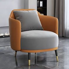 an orange and grey chair sitting on top of a floor next to a fire place