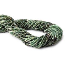 a green beaded bracelet with beads on it's end and one strand in the middle