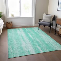 a living room area with a chair, rug and window