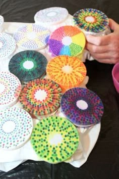 a table topped with lots of colorful paper plates