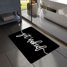 a bathroom rug with the word bath written in cursive white on a black background