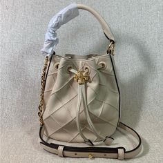 Brand New Never Been Carried Mini Soft Fleming Bucket Bag By Tory Burch. This Bag Is Made Of Cream Quilted Soft Genuine Leather Dimensions: 6” Wide X 7” Tall Center X 3.5" Deep. Strap 22" Drop Drawstring Top Closure Interior: Single Compartment Fabric Lining. Gold Tone Metalware. Vip Access Item. Tag Was Removed To Prevent Store Returns. Designer Beige Bucket Bag For Formal Occasions, Designer Beige Bucket Bag For Formal Events, Luxury Cream Bucket Bag With Gold-tone Hardware, Designer Cream Bucket Bag With Gold-tone Hardware, Luxury Cream Bucket Bag, Luxury Cream Pouch Bucket Bag, Luxury Cream Bucket Bag In Pouch Shape, Luxury Cream Crossbody Bucket Bag, Mini Bucket