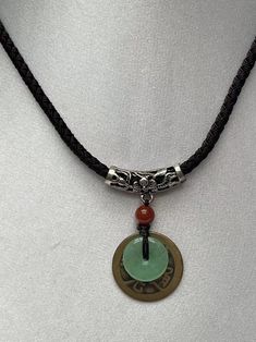 Green Jade Donut with Lucky Coin Antique Design brown color Nice Nylon Cord. Jade Donut means Wealth, Peaceful, Safe and Good Luck. Lucky Coin for protection , money and good fortune. Peoples believe that Jade and Coin can bring them wealth and Safe. This is excellent gift to families & friends. The necklace cord use the silk cord to hang it on.The closure is adjustable up14 inches to 22 inches. Material : Jade donut, Brass coin, Nylon cord Jade size : 1.5cm round, Lucky Coin 2.5 cm round Jade B Accesories Aesthetic, Necklace With Meaning, Jade Jewelry Necklace, Lucky Necklace, Color Jade, Indie Jewelry, Silk Bag, Necklace Cord, Dope Jewelry