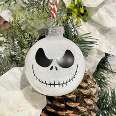 a white ornament with a jack skellingy face on it's side