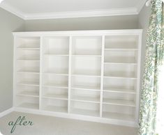 an empty white bookcase in the corner of a room