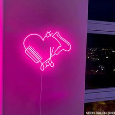 a pink neon sign with a hair dryer and comb in the shape of a heart