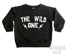 'The Wild One' kids black sweatshirt. ** Our sweatshirts fit true to size but we always recommend ordering a size bigger just to make sure ** Age / Size - Standard Universal Sizes * 6-12 Months / 17-24 Lbs * 1-2 Years / Chest (to fit): 22 inch * 2-3 Years /Chest (to fit): 24 inch * 3-4 Years / Chest (to fit): 26 inch * 4-5 Years / Chest (to fit): 27 inch * 5-6 Years / Chest (to fit): 28 inch * 7-8 Years / Chest (to fit): 30 inch * 9-11 Years / Chest (to fit): 33 inch * Made from soft heavyweight Black Cotton Sweatshirt With Lettering, Unisex Black Crew Neck Sweatshirt, Black Band Merch Sweatshirt With Slogan, Black Band Merch Sweatshirt Pre-shrunk, Black Band Merch Sweatshirt, Pre-shrunk, Black Crew Neck Sweatshirt With Lettering, Black Slogan Sweater For Streetwear, The Wild One, Black Sweatshirt