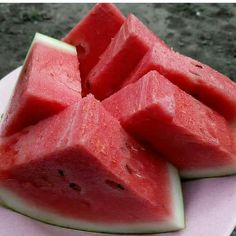 slices of watermelon on a plate with one cut in half and the other whole