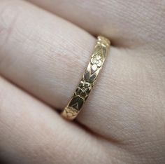 This vintage-inspired floral ring is a row of dainty flowers wrapped around your fingers. If you shy away from flashy accessories and prefer beauty in fine details this original vintage-style ring is perfect fo you. This ring is modelled specially to size and has no visible seam marks on it. This ring is designed in 3D and not made out of wire or soldered but cast directly in your size so there are no solder marks on the ring whatsoever. Material: 8 or 14 Karat Solid  Rose, Yellow or White Gold( Dainty Gold Flower Ring Stamped 14k, Dainty Engraved Toe Ring For Wedding, Tiny Stackable Wedding Rings Round Band, Tiny Stackable Round Band Rings For Wedding, Delicate Engraved Rose Gold Ring For Wedding, Tiny Elegant Flower Ring For Weddings, Tiny Stackable Wedding Rings, Delicate Gold Engraved Ring For Wedding, Yellow Gold Flower Ring With Intricate Design For Wedding