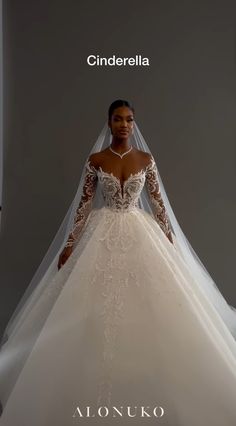 a woman in a white wedding dress with long sleeves and a veil on her head