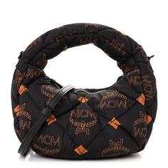 This an authentic MCM Maxi Visetos Nylon Quilted Mini Aren Hobo in Black. The chic bag is crafted of MCM monogram patterned quilted nylon in black and orange. This bag features a fabric top handle and optional leather shoulder strap with black matte hardware. The top zipper opens to a black fabric interior. Designer Nylon Shoulder Bag With Detachable Handle, Designer Nylon Top Handle Bag, Designer Nylon Shoulder Bag With Top Carry Handle, Designer Quilted Nylon Bags, Luxury Nylon Pouch Bag, Black Matte Hardware, Chic Bags, Black And Orange, Fabric Bag