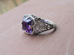 Vintage Sterling Silver Princess cut Amethyst Filigree Ring ...Marked 925...Total of weights 3.4grams...Size 8...Measure of Face 12.9MM...It's in very good condition. Purple Amethyst Ring With Intricate Design, Purple Amethyst Ring With Intricate Design For Promise, Art Deco Purple Amethyst Ring For Anniversary, Purple Amethyst Promise Ring With Intricate Design, Purple Promise Ring With Intricate Design, Purple Amethyst Art Deco Ring For Anniversary, Purple Intricate Design Promise Ring, Purple Anniversary Rings With Intricate Design, Purple Hallmarked Art Deco Amethyst Ring