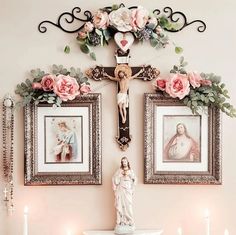 a wall with pictures and candles in front of it, including a statue of the virgin mary