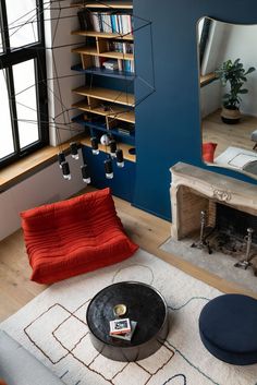 a living room filled with furniture and a fire place next to a large mirror on the wall