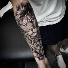 a man with a lion tattoo on his arm