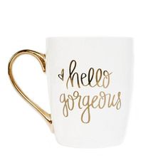 a white and gold coffee mug with the words hello gorgeous on it's side