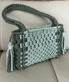 a crocheted purse sitting on top of a couch