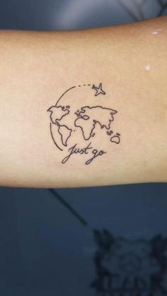 a person's arm with a small world map tattoo on the left inner arm