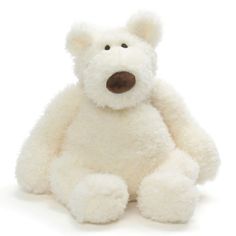 a white teddy bear sitting up against a white background