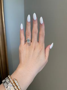 a woman's hand with white manies and a ring on her left wrist