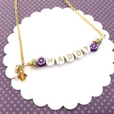 "Beaded Name Necklace for Kids, Birthday Jewelry for Girls, Beaded Bar Necklace, Personalized Gift, Children's Jewelry, Custom Name Jewelry ------------------------ This cute beaded little name necklace makes a special birthday gift for your favorite little girl! Letter beads with a custom name are strung on heavy wire and then attached to a chain with a lobster claw clasp. Purple accent flowers are on either side along with sparkly rhinestone spacers, a Swarovski Crystal birthstone bead, and a Beaded Name Necklace, Necklace For Kids, Accent Flowers, Bead Bar Necklace, Children's Jewelry, Bead Bar, Bar Necklace Personalized, Special Birthday Gifts, Jewelry For Girls