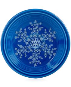 a blue plate with white snowflakes on it