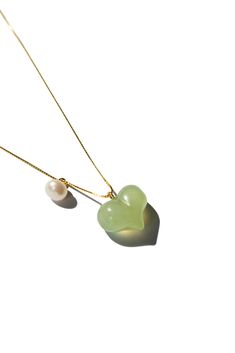 Necklace Nephrite The Puffed Heart Necklace features a green jade heart pendant, puffed to perfection, complemented by a delicate pearl. The unique puffed design of the jade heart adds a playful touch, making it an irresistibly cute accessory. Length: 17.5"Weight: 20gHeart pendant: 10mm x 13mm x 5mmMaterial: Nephrite, pearl, gold-plated sterling silver [#other] Product care Avoid knocking against hard surfaces. Jade pieces are brittle and will break when hit with hard objects. Make sure that you Puffed Heart Necklace, Go Swimming, Puffed Heart, Pearl Pendant Necklace, Jade Stone, Green Necklace, Green Jade, Jade Green, Pearl Pendant