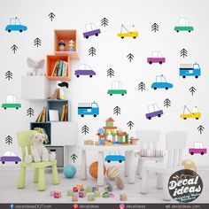 a child's playroom with toys and wall decals in various colors, including cars