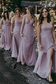 the bridesmaids are walking down the road together