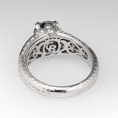 an antique style engagement ring with filigrees and diamonds