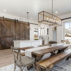 a kitchen with a table and benches next to a sliding door that leads to an outdoor deck