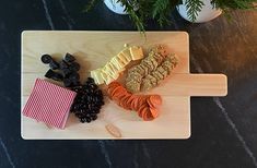 a wooden cutting board topped with different types of food