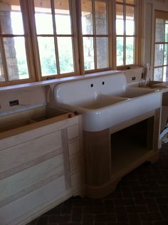 a kitchen with two windows and a sink in it's center, next to the counter