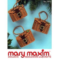 three crocheted bags hanging from a christmas tree with the words mary maxm on it