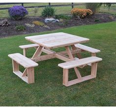 a picnic table and benches in the grass