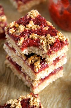 three pieces of strawberry crumbler bars stacked on top of each other