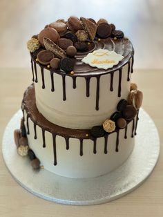 a three layer cake with chocolate and cookies on top