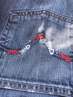 the back pocket of a pair of jeans with red stitchs