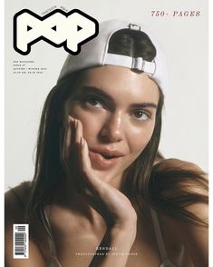 a woman wearing a white hat on top of a magazine cover with her hand under her chin