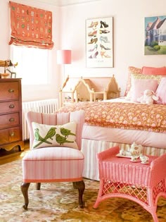 a bedroom decorated in pink and white with lots of furniture