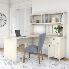 a computer desk with a laptop on top of it and a chair in front of it