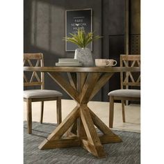 a wooden table with two chairs and a potted plant on top of the table