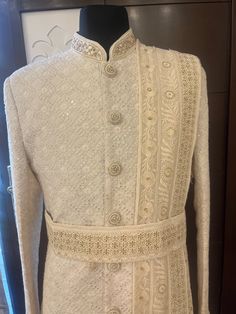 handmade beige sherwani with hand weaving thread work and red stone work package include: top- sherwani                             bottom- churidar pajama  we also customise the whole outfit like different accessories / sherwani fabric shoes / necklace etc Nehru Jacket With Resham Embroidery For Reception, Reception Nehru Jacket With Resham Embroidery And Traditional Drape, Designer Embroidered Sherwani For Festive Occasions, Designer Bandhgala With Resham Embroidery, Designer Off-white Bandhgala With Resham Embroidery, Designer Off White Traditional Wear With Chikankari Embroidery, Designer Off-white Traditional Wear With Chikankari Embroidery, Designer Resham Embroidery Sherwani For Diwali, Designer Traditional Wear With Cutdana For Reception